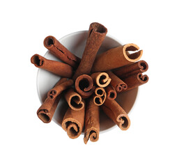 Cinnamon sticks in bowl isolated on white, top view