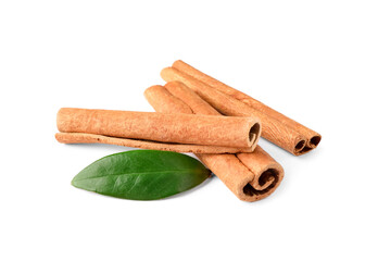 Cinnamon sticks and green leaf isolated on white