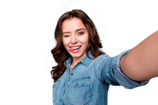 Self-portrait of nice cute flirty cheerful lovely attractive adorable magnificent brunette girl with wavy hair in casual denim shirt, showing tongue out, winking, isolated over grey background