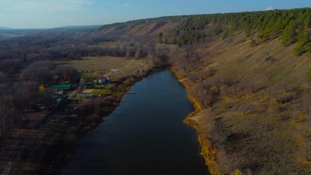 Autumn Tapestry Aerial Views of Russia Nature Drone Footage Over Volga River, Forest, and Mountains. Grushinsky Festival Meadow in Warm Glow. Russia, Samara, Samara region