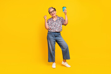 Full size photo of pretty retired female hold excited hold paper cup wear trendy leopard print...
