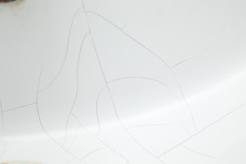 The washbasin is white with cracks.