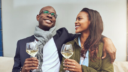 black couple having a great time together while smiling and enjoying a glass of white wine - 740675543