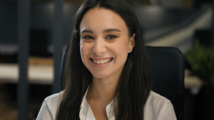 Caucasian businesswoman working in office looking at camera smiling sitting at company corporate workplace smile toothy business woman employer girl female secretary manager positive joyful portrait
