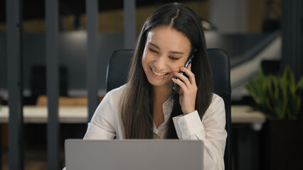 Business corporate work emotional smiling businesswoman working with computer talking mobile phone...