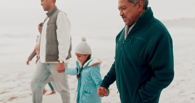 Beach, family and grandparents with children in nature for holiday, vacation and adventure in winter. Family, travel and mother, father and kids holding hands for bonding, walking and relax by sea
