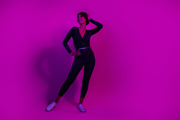 Fototapeta na wymiar Full body photo of attractive young woman posing look empty space wear trendy overall clothes isolated on neon light pink color background