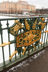 St. Petersburg, Russia, February 4, 2024. Gilded decorations of the fence of the old bridge.