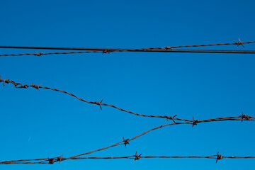 spiked metal fence sky blue