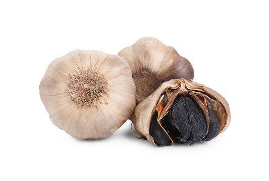 Bulbs of fermented black garlic isolated on white
