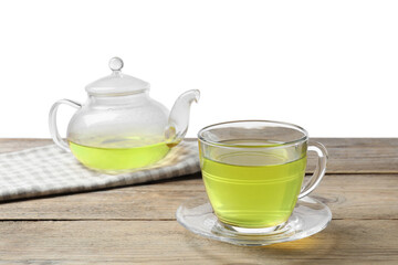 Refreshing green tea in cup and teapot on wooden table against white background