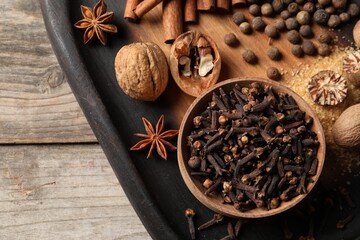 Different spices on wooden table, top view