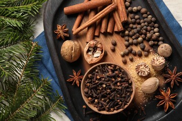 Different spices and nuts on table, flat lay