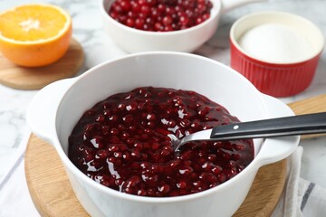 Fresh cranberry sauce in bowl served on table, closeup