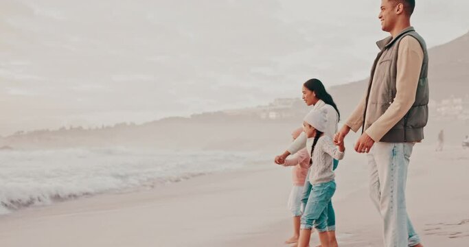 Beach, walking and parents with children for holiday, vacation and adventure in winter. Family, travel and mother, father and kids holding hands for bonding, relationship and relax together by sea