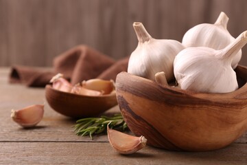 Fresh garlic on wooden table, closeup. Space for text
