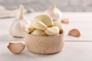 Fototapeta na wymiar Fresh garlic on white wooden table, closeup