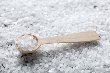 Natural salt and wooden spoon, closeup view