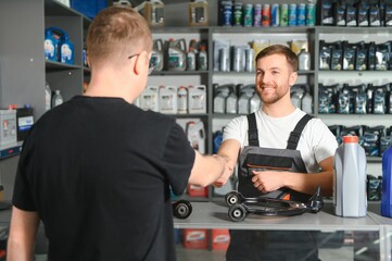 The seller selects new car repair parts for the client