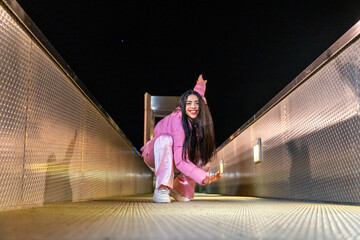 Free style dancer performing sitting on a bridge at night