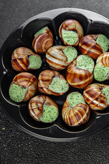 snails with green oil aromatic herbs tasty fresh healthy eating cooking appetizer meal food snack on the table copy space food background