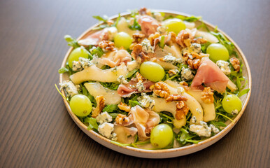 delicious salad with prosciutto, grape, and arugula