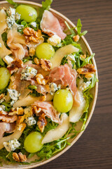 delicious salad with prosciutto, grape, and arugula