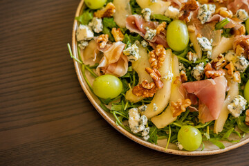 delicious salad with prosciutto, grape, and arugula