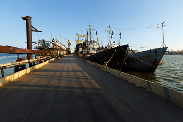 Floating pontoon bridge at shipyard, maintenance of marine vessels underway, maritime industry,...