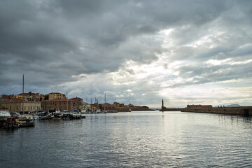 Fototapeta na wymiar sailboats, historic buildings and tourists in the port of Chania on the island of Crete
