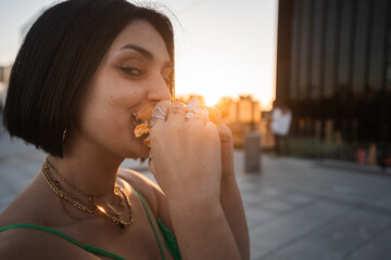 Woman Enjoying a Burger in Madrid's 4 Towers Area