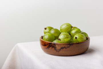 Gooseberry in a wooden bowl
