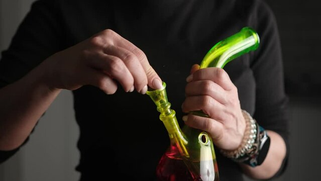 Woman Preparing Bong For Smoking Cannabis Cbd And Thc Weed, Concept Of Drug Use And Addiction In Legalize Regions