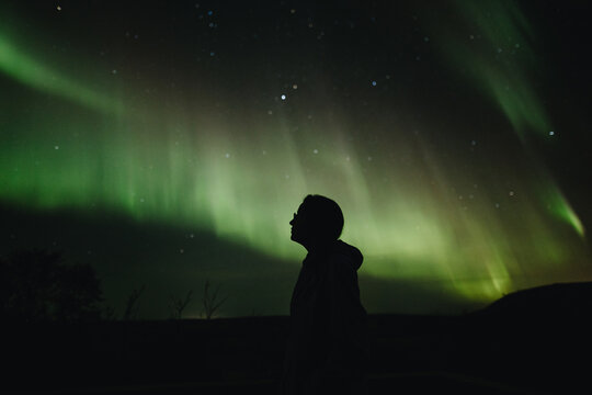 Silhouette of a man under the Northern Lights in Iceland