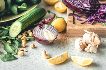 Close-up, half an onion on a kitchen table with fresh vegetables for salad.