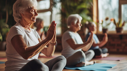 Older women practice yoga, meditate in yoga classes and lead an active and healthy lifestyle. Retirement hobbies and leisure activities for the elderly. Bokeh in the background.  - obrazy, fototapety, plakaty