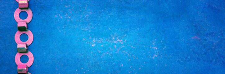 Abstract grunge blue metallic background from extended nuts and washers. Horizontal banner