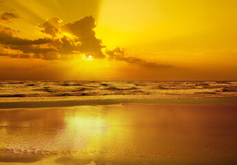 Early morning. Golden sunrise over the sea with a cloudy sky. Stormy weather - Powered by Adobe