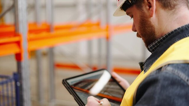 The quality manager engineer checks the constructed metalwork object for compliance with the 3D model in the tablet.
