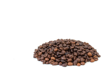 Pile of coffee beans in the center of a white table. Front view. Horizontal composition.