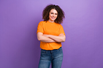 Photo of positive confident lady dressed orange t-shirt smiling arms crossed isolated violet color background