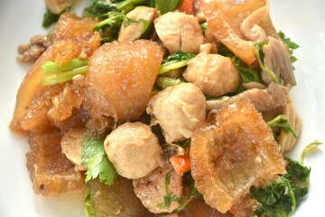 fried slice pork skin with pork meatball and mushroom on plate 