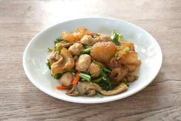 fried slice pork skin with pork meatball and mushroom on plate 