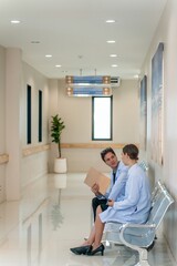 White male and female doctors taking a break sitting and talking to each other