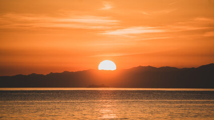 Sunset over the mountains in the beach