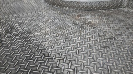 Metal floor with crossing pattern in production room of factory 