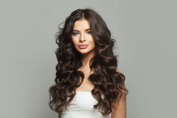 Young perfect healthy brunette model woman with long shiny dark hairstyle and fresh clean skin on...