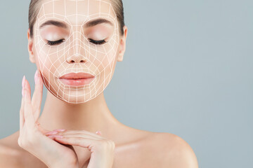 Good-looking woman with massage or surgery lines on her face. Medicine, cosmetology and facial treatment concept - 740748107