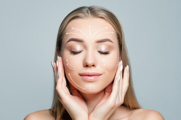 Charming woman with massage or surgery lines on her face. Medicine, cosmetology and facial...