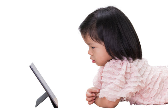 Asian Child Girl Reading On Tablet At School. Preschool Kid Using A Computer At Home. Isolated On White Background. Baby Aged 4 Years Old.